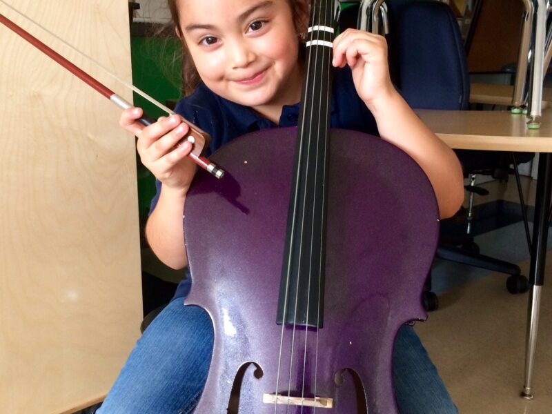 A young girl plays the cello